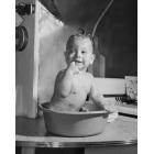 Baby in a bathtub with its finger in its mouth Canvas Art -  (18 x 24)